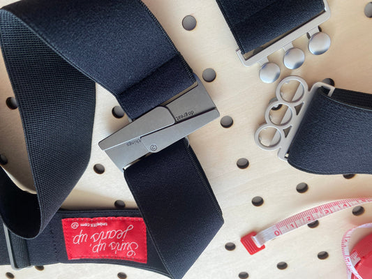 Two black Classic Unbelts on a worktable